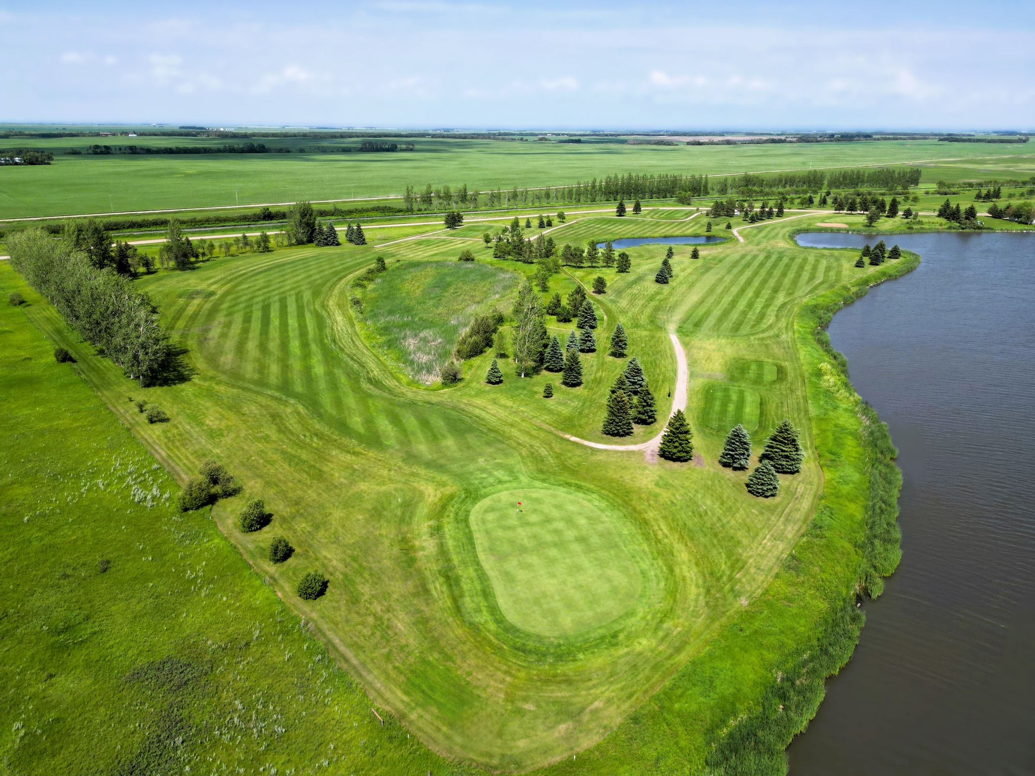 Aerial view of golf course with pond